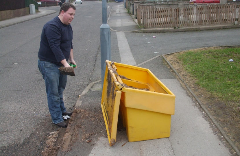 Gary Sambrook clearing up the mess from an overturned grit bin.