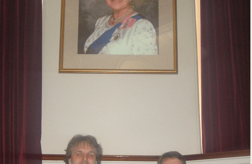 Robert and Gareth by the portrait of the Queen