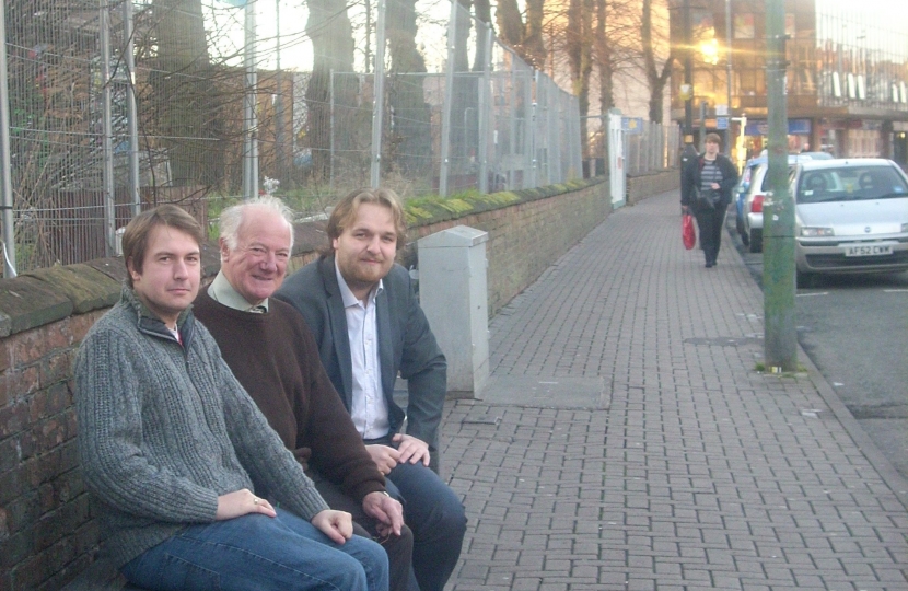 Gareth, Bob and Robert siting on a bench outside St Barnabas Church, Erdington