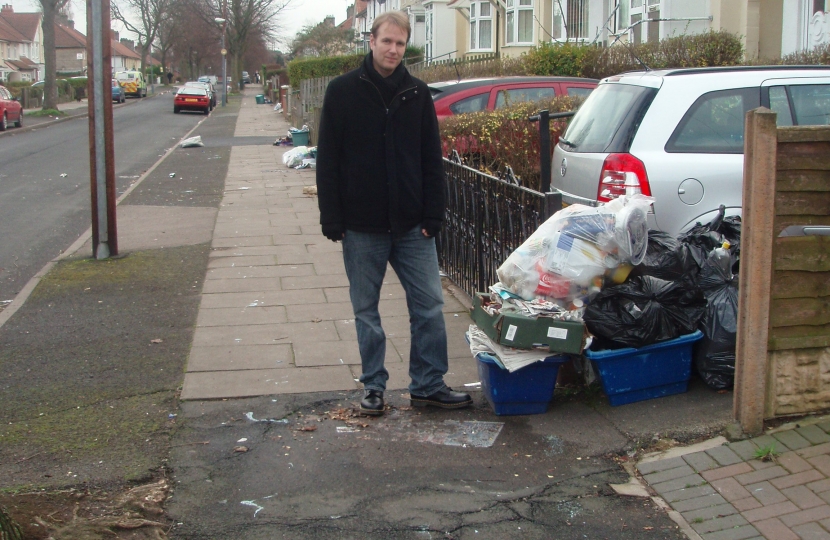Cllr Matt Bennett next to uncollected rubbish bags on Brookvale Park Road