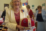 Local resident Wendy Bevan proudly holding the knitted crown she made