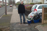 Cllr Matt Bennett next to uncollected rubbish bags on Brookvale Park Road